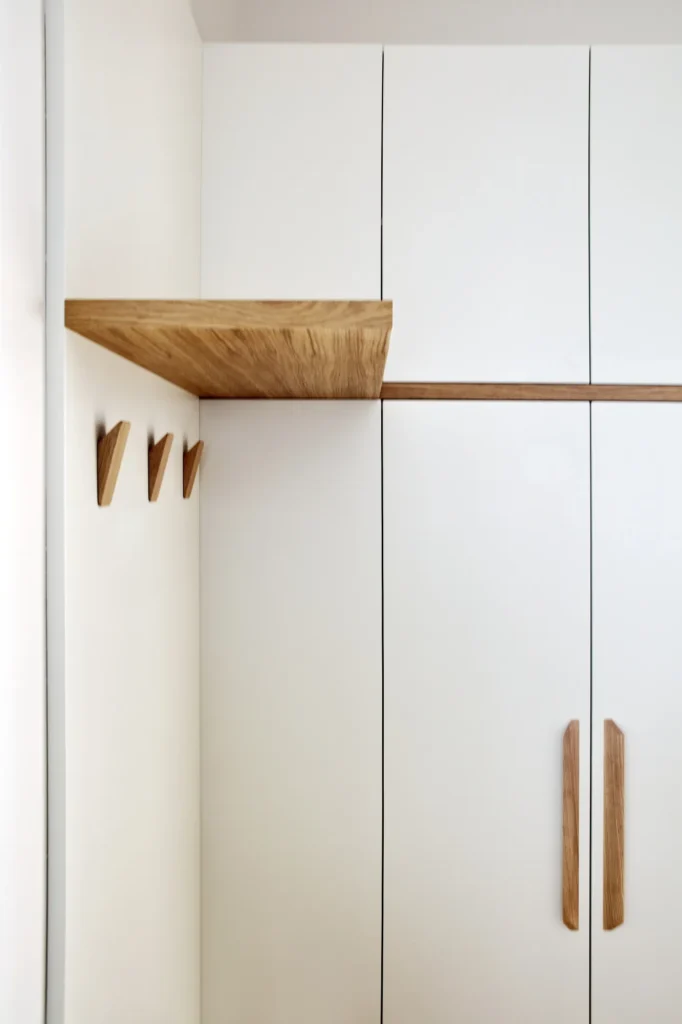 Custom-made closet with wooden handles and hooks/ Interior designer Prague Olina Puchalova